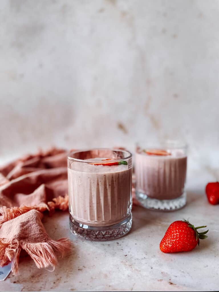 glass of pink strawberry oat breakfast smoothie